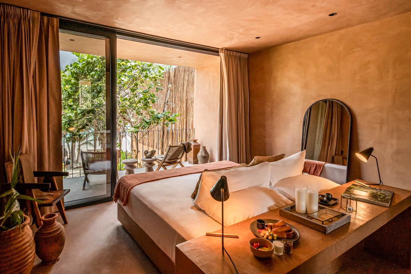 King bed and writing desk facing the sliding doors to the private terrace