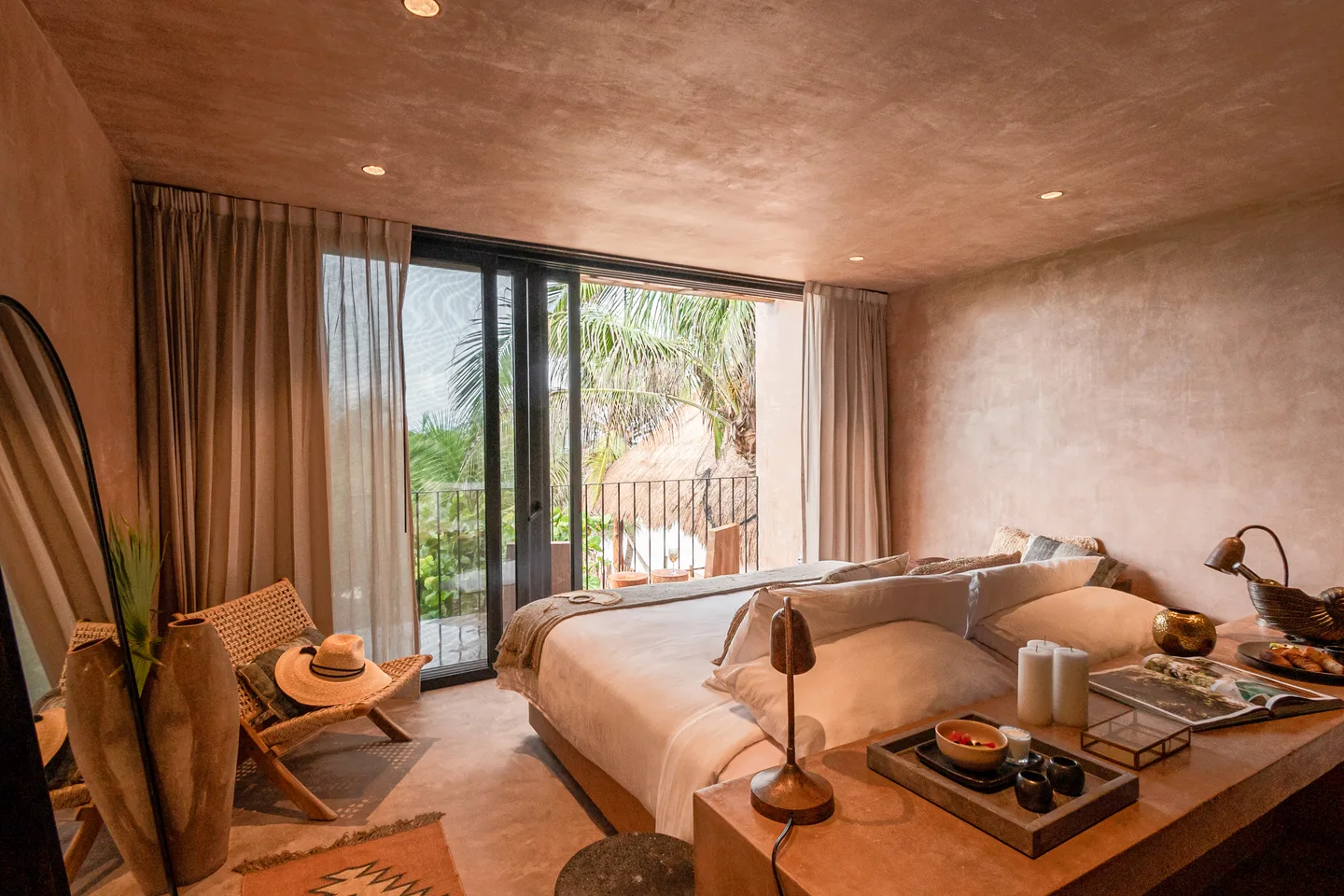King bed and desk facing the balcony doors and palm trees