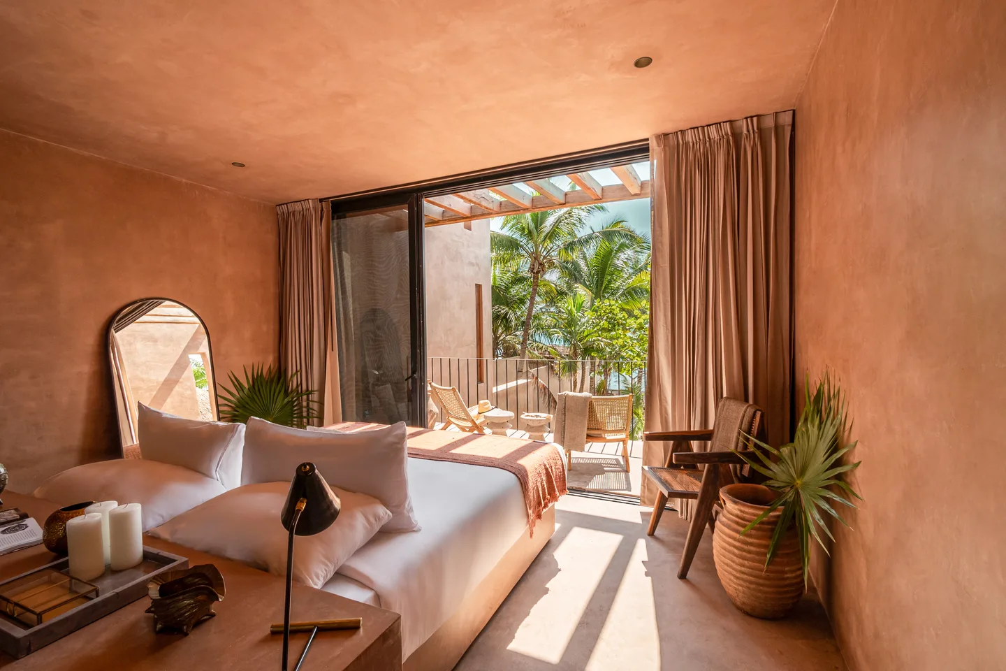 King bed and desk opening onto the pergola terrace
