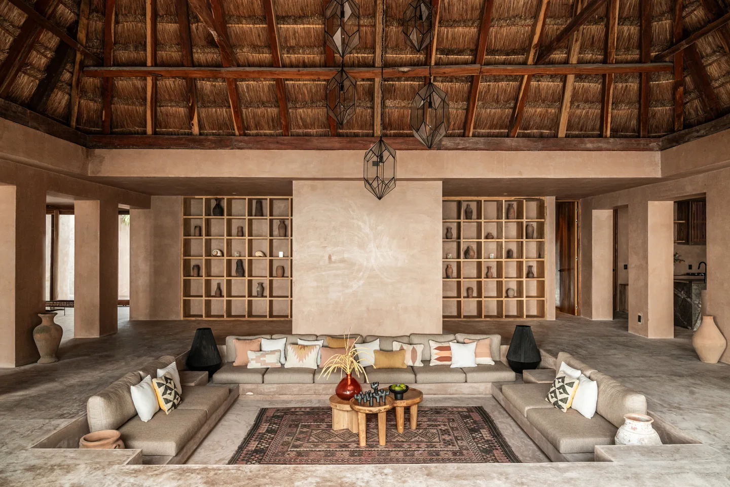 Lobby with a sunken lounge beneath a soaring thatched palapa roof